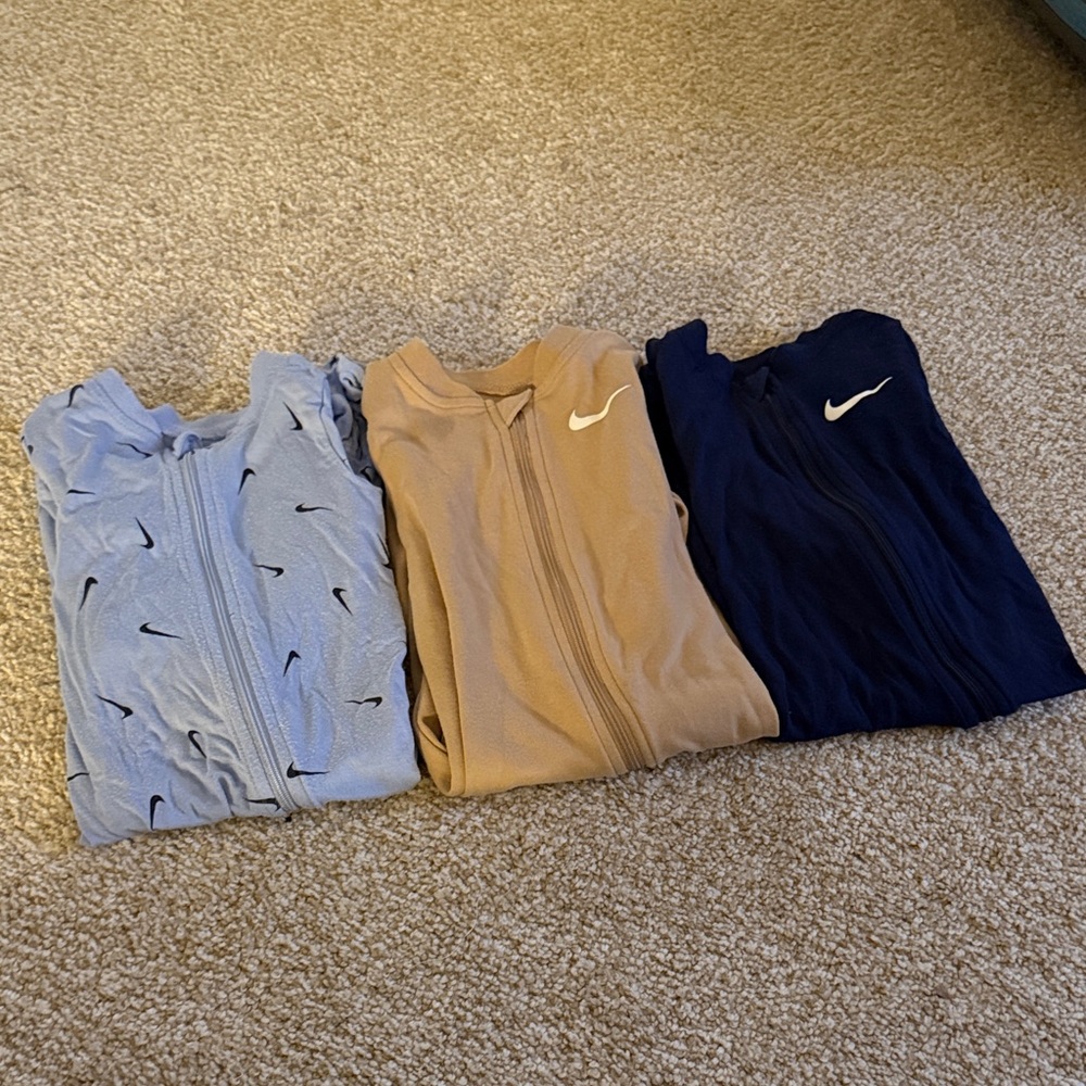 Nike Footie Pajamas in Light Blue, Beige, and Dark Blue